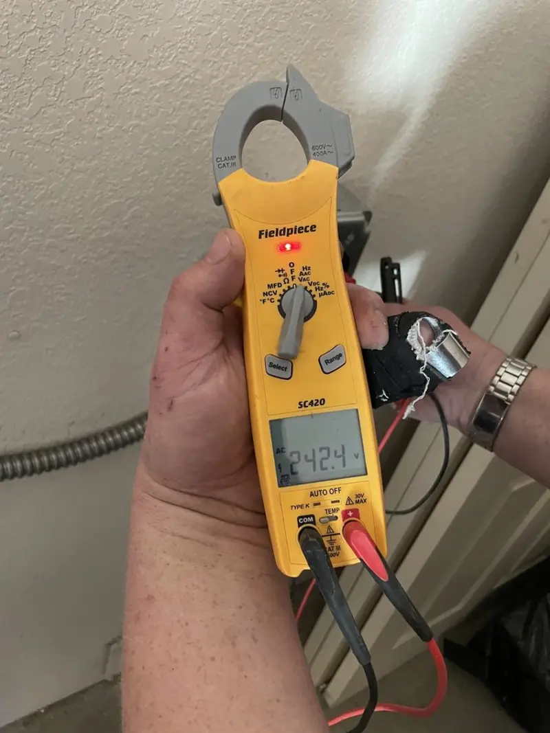 Voltage testing with clamp meter during Ceiling Fan Installation in Westlake